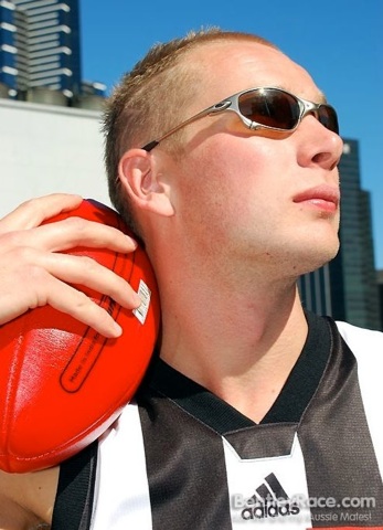 Blond Aussie jock poses for a glamour shot with his ball