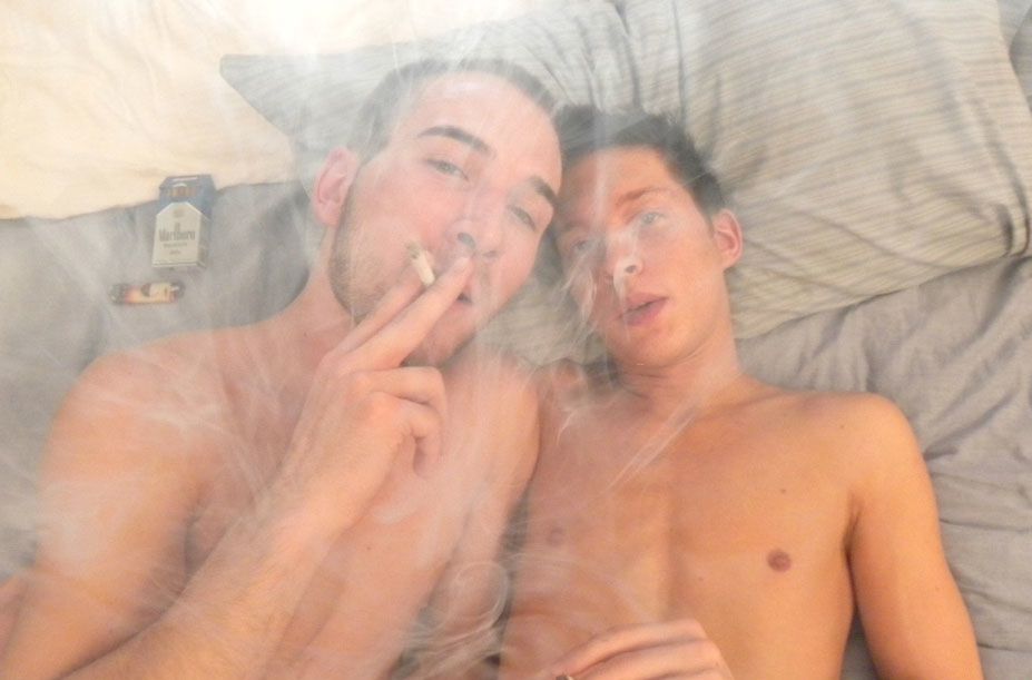 Jacob Wright and Ryan Conners naked in bed smoking