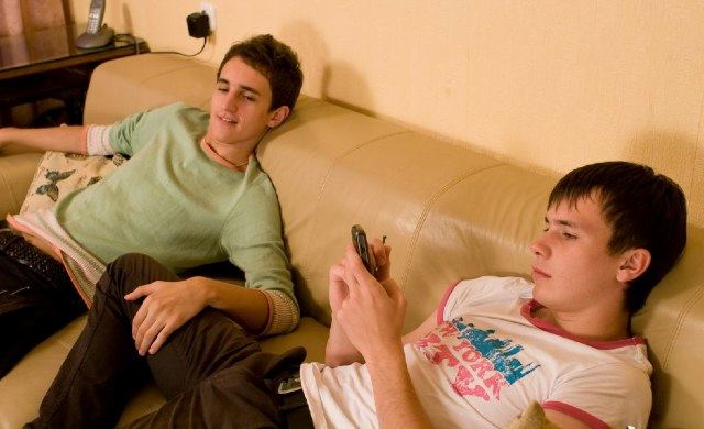 Cute young guys hanging out on the couch