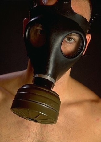 Hot young guy in a gas mask