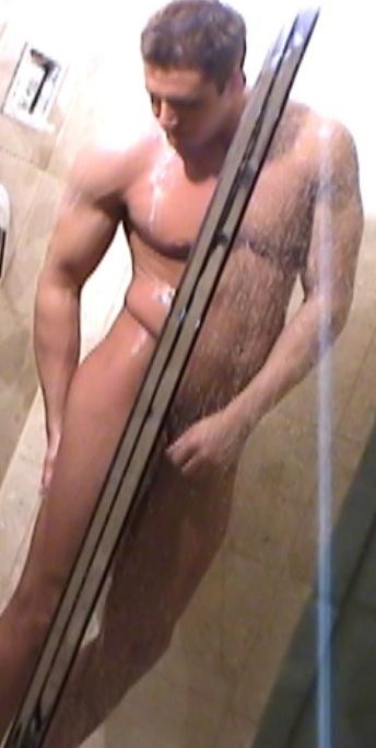 Sexy stud soaps up and rinses off in a hot shower
