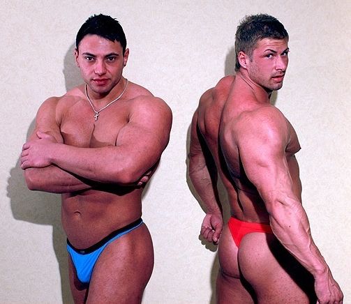 Hairless bodybuilders pose in thongs