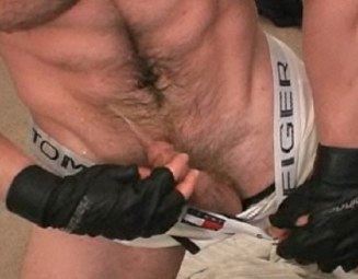 Hairy guy pissing on himself