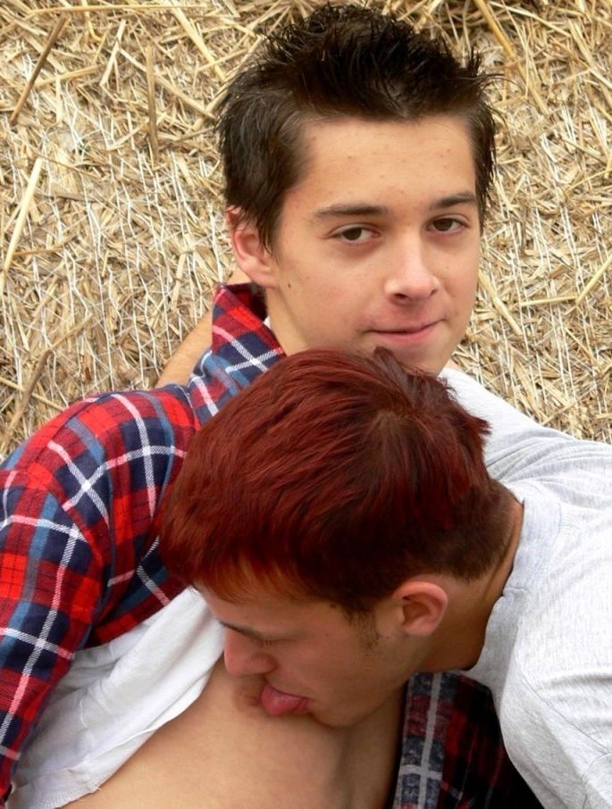 Cute young twinks play around in the hay