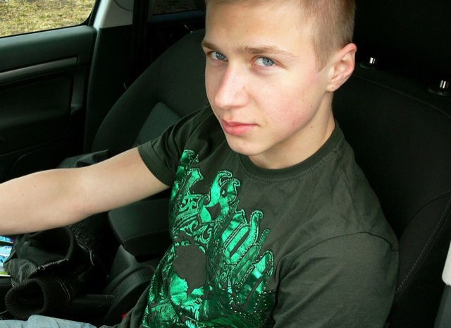 Cute young blond twink in his car