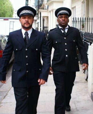 Two beefy guys in police uniforms