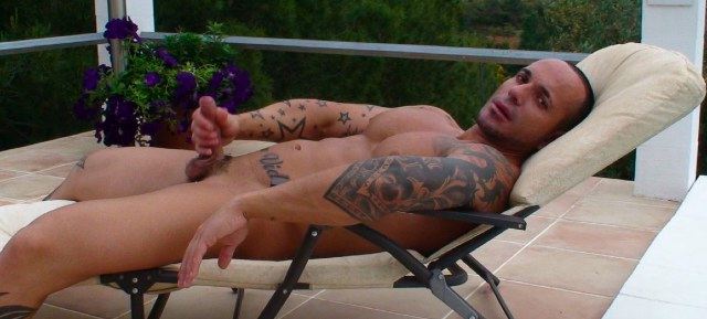 Tattooed Latin muscle boy stroking his cock