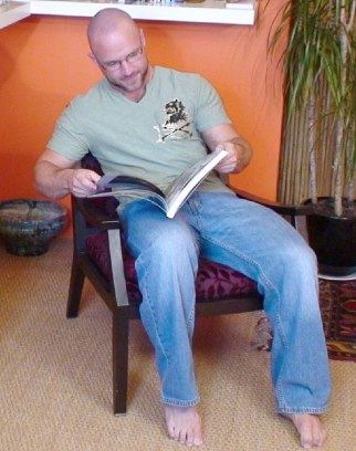 Hot guy with shaved head reading a book