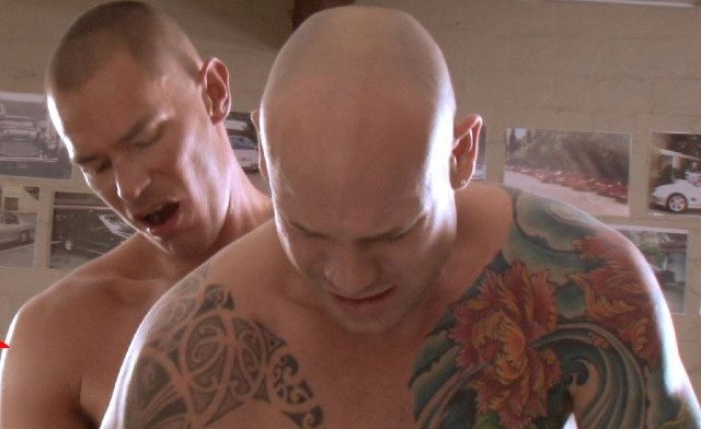 Tattooed bald guy bends over, getting fucked