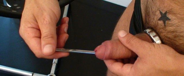 Leather stud shoves a sound down his thick cock