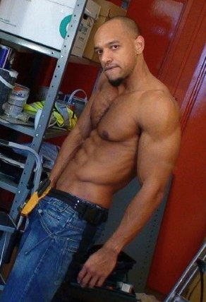 Muscle hunk rubs his cock under his tight blue jeans