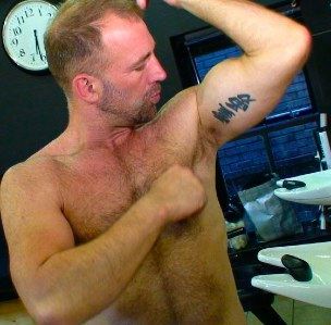 Parker William showing his tat and flexing his bicep