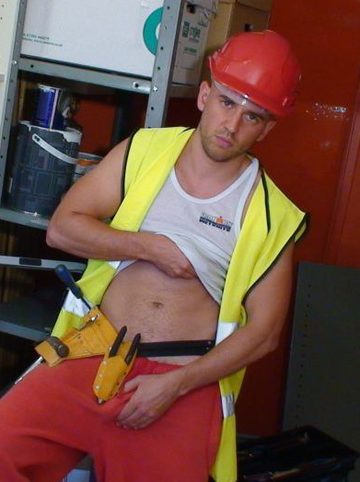 Workman in toolbelt shows off his belly