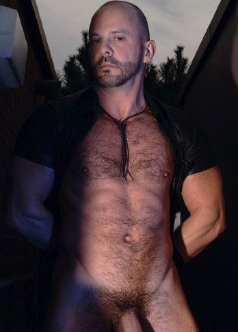Buff man Carlo Cox shows off hairy pecs and washboard abs