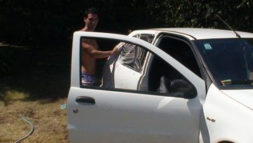 Stud washing his car