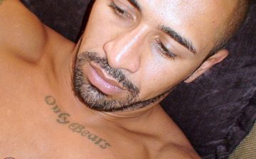 Scruffy Latino guy with chest tattoo