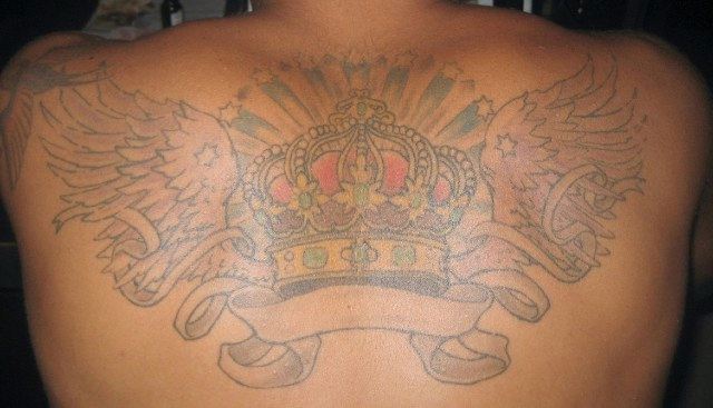 Ink work on the back of muscled Latin guy
