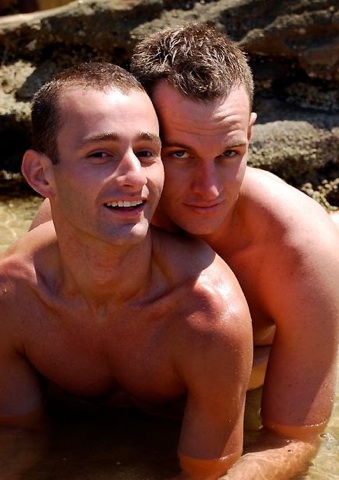 Two guys at beach cuddling