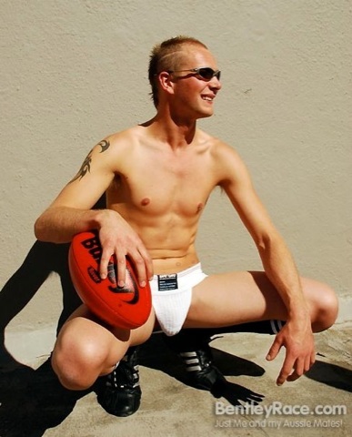Smooth blond guy poses in a jockstrap