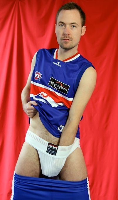Aussie in sports gear with his hand down his jockstrap