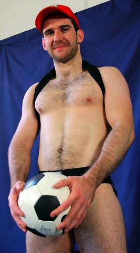 Scruffy furry muscle boy with soccer ball