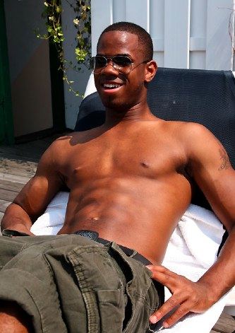 Shirtless jock laying in the sun