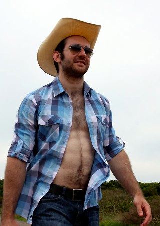 Shirtless scruffy young cowboy