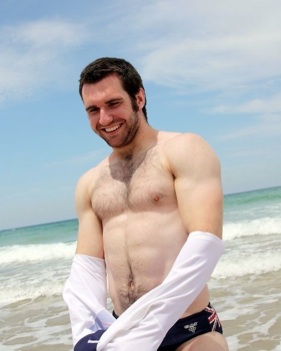 Furry muscle cub stripes at the beach