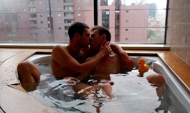 Naked young guys make out in the hot tub