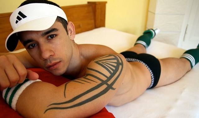 Inked jock Daniel Carrera in his underwear on the bed