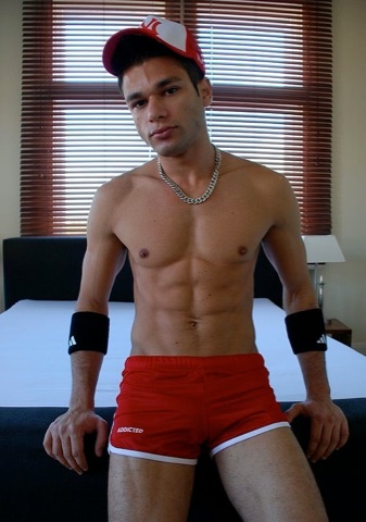 Ripped young jock in running shorts