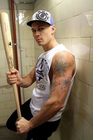 Inked trainer Tate Ryder with a baseball bat