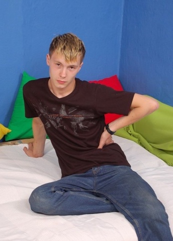 Cute young twink sitting on bed