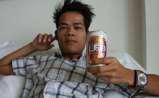 Cute young Asian twink drinking beer