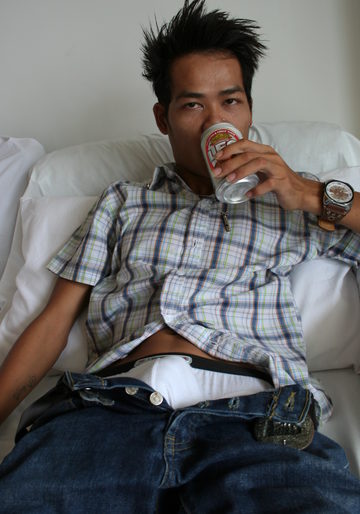 Young Asian guy drinking beer