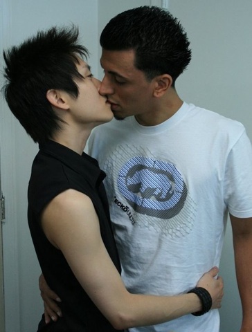 Young Latin man making out with an Asian twink