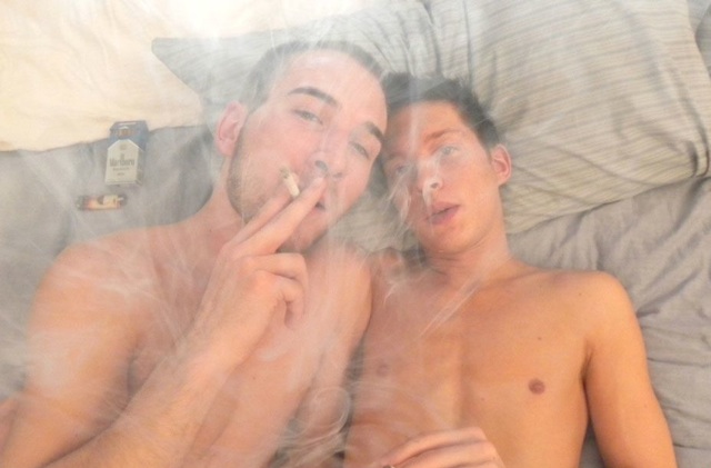 Jacob Wright and Ryan Conners naked in bed smoking