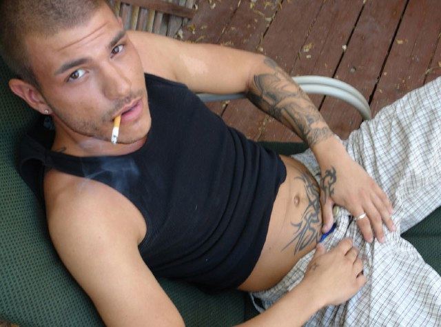 Smoking punk grabs his bulge