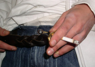 Close-up of cigarette and belt.