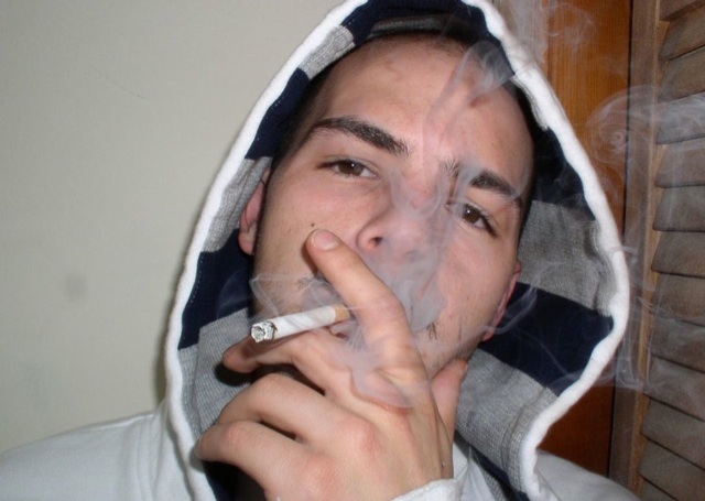 Face shot of hot white dude smoking.