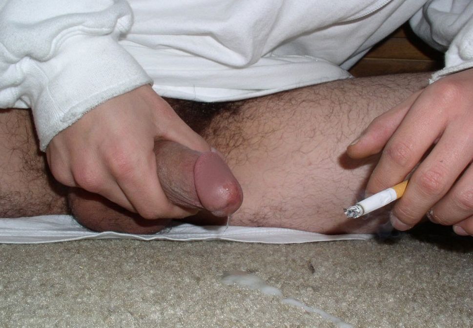 Close-up of white tugh dick and cigarette.