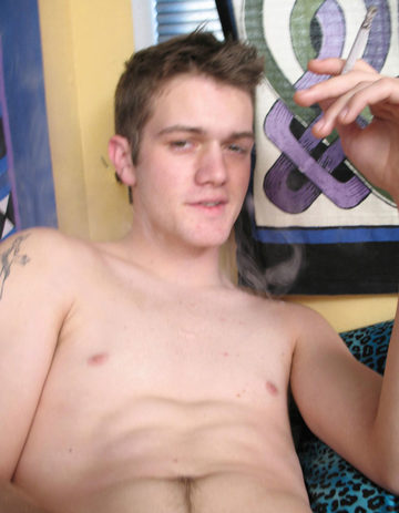Young twink smokes with his shirt off