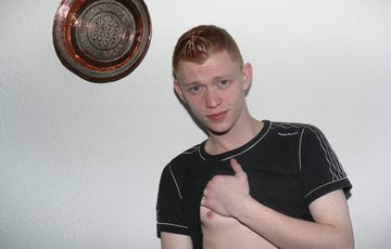 Young red head pulling his shirt up and showing his nipple