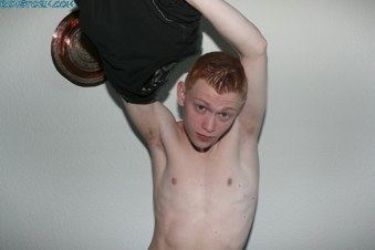 Red-headed twink taking off his shirt