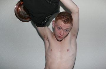 Red-headed twink taking off his shirt