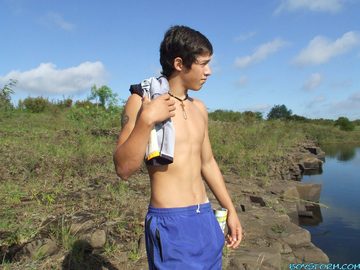 Hot shirtless teen at the water\'s edge