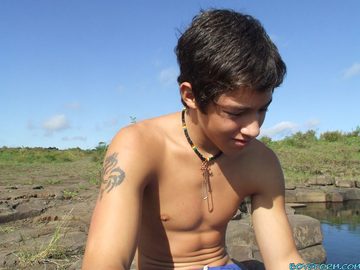 Cute twink bare chested by the water