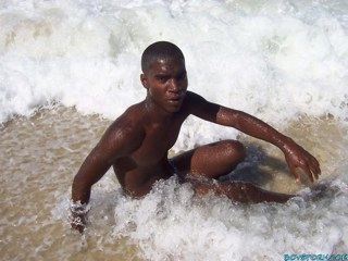 Hot young black guy naked in the surf