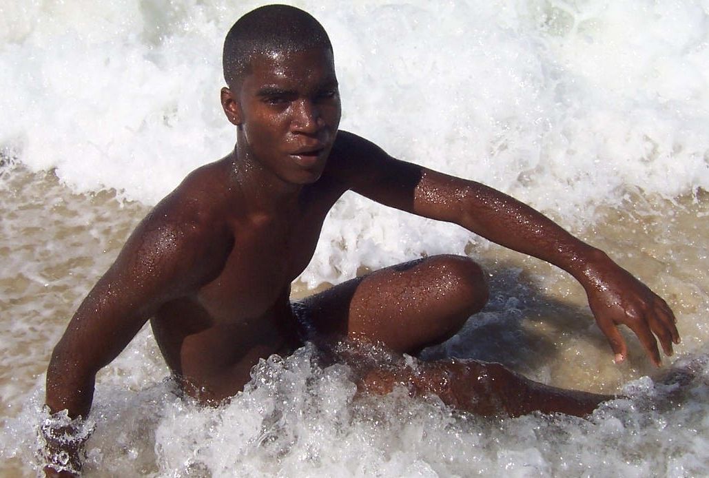 Hot young black guy naked in the surf