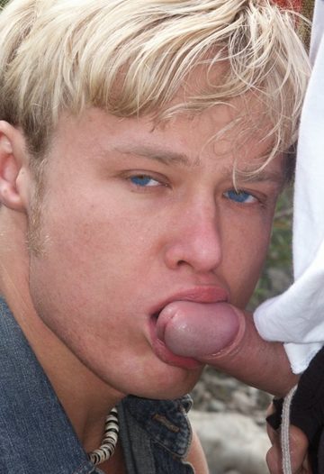 Blond guy wraps lips around head of uncut teen cock